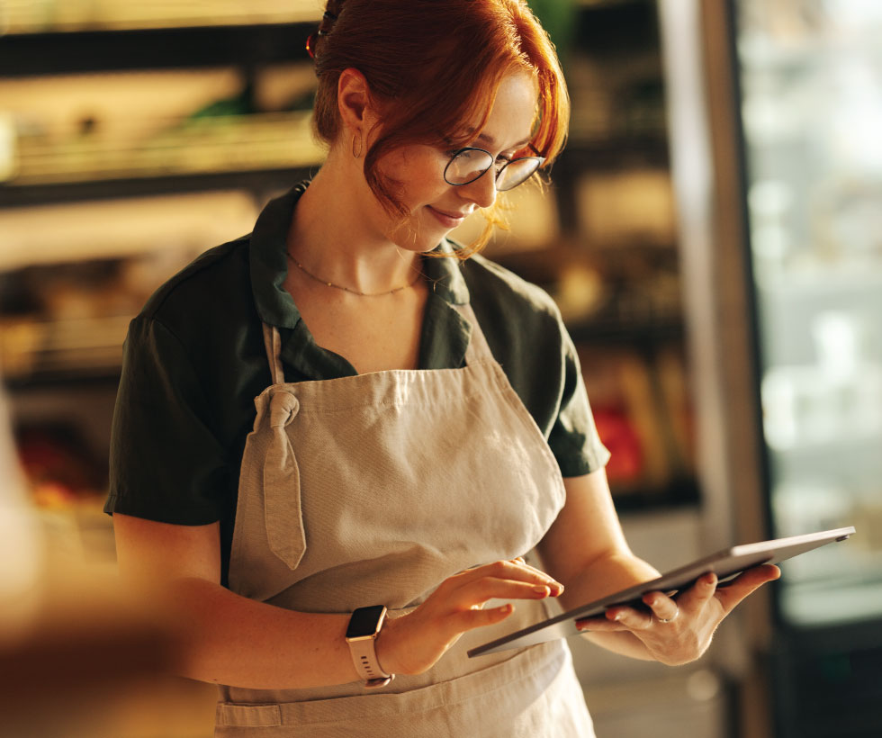 Grocery store owner using tablet