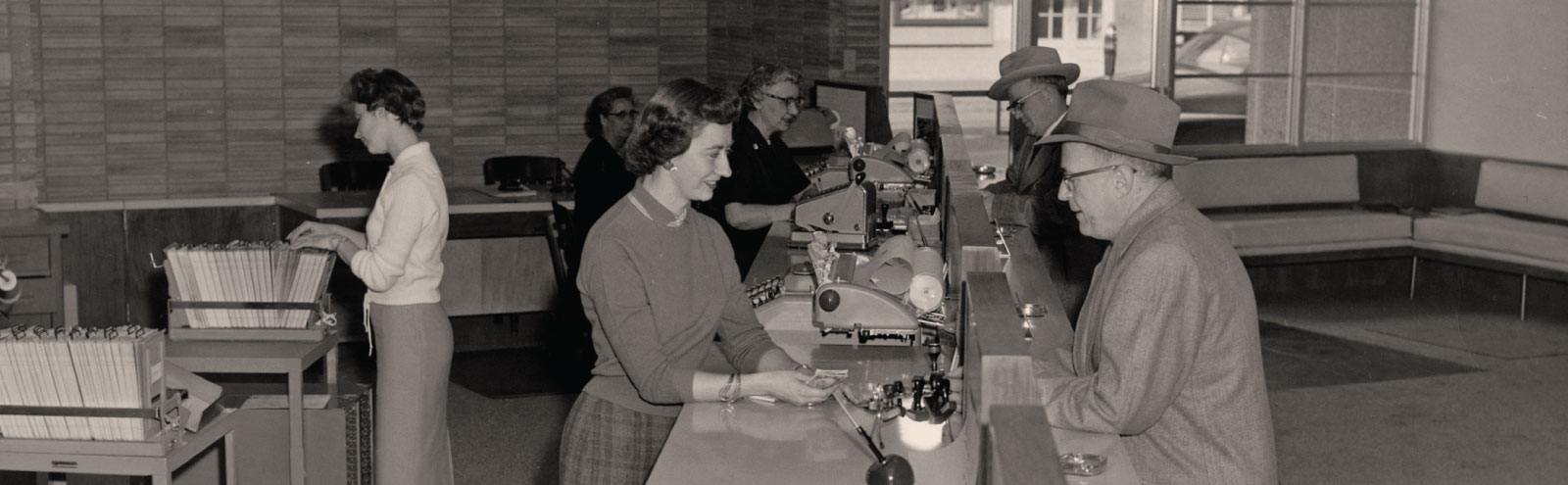 Tellers helping customers at First Federal's bank in downtown Sheridan, Wyoming in the 1970s.