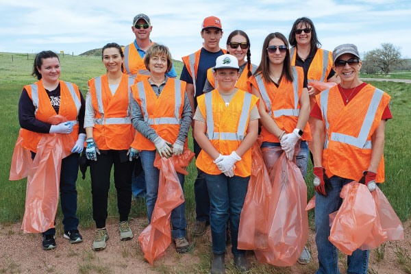 group of volunteers cleaning highway