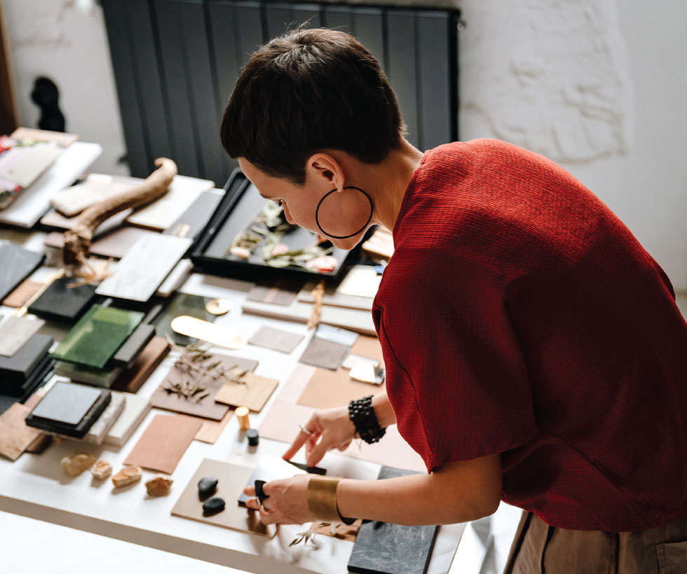 Interior designer looking down at materials.