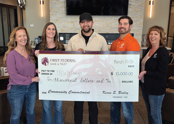 First Federal employees and members of TedxBillings holding a donation check for $10,000.