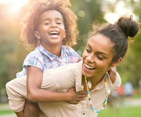 A mom and son playing in a park