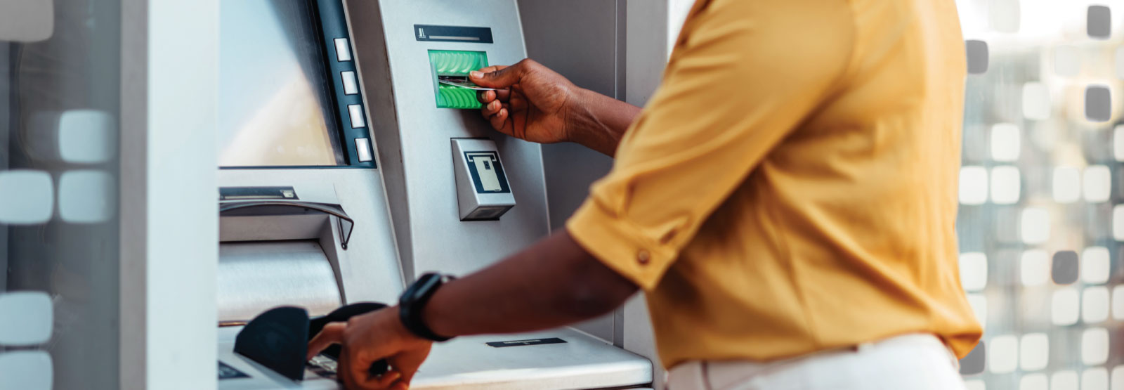 Person using card at an ATM