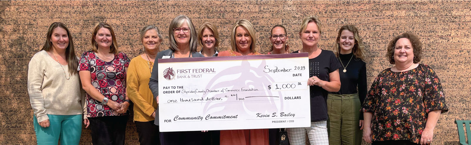 Group of people holding a check for the Sheridan County Chamber of Commerce Foundation