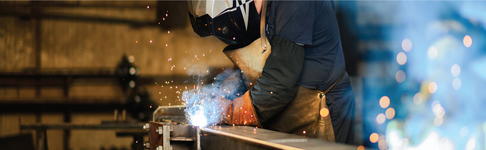 Man welding a metal plate