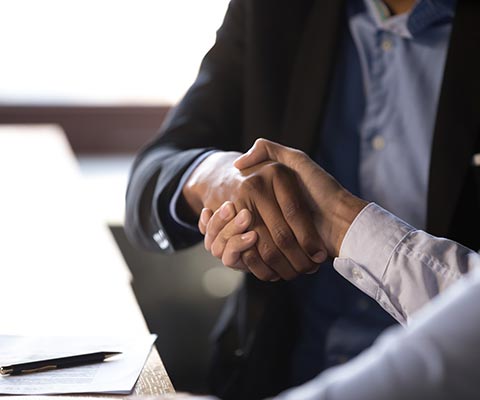 Two businessmen shaking hands in an office