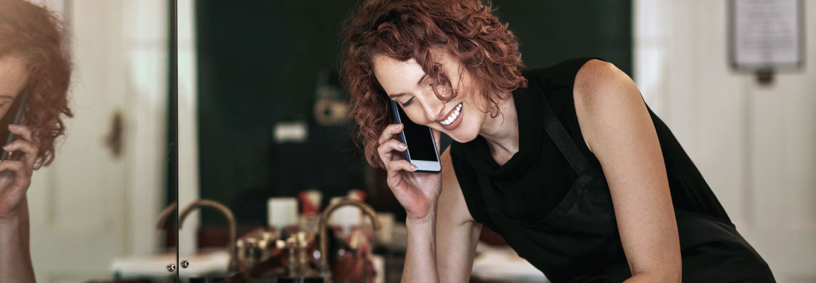 Salon owner on mobile phone.