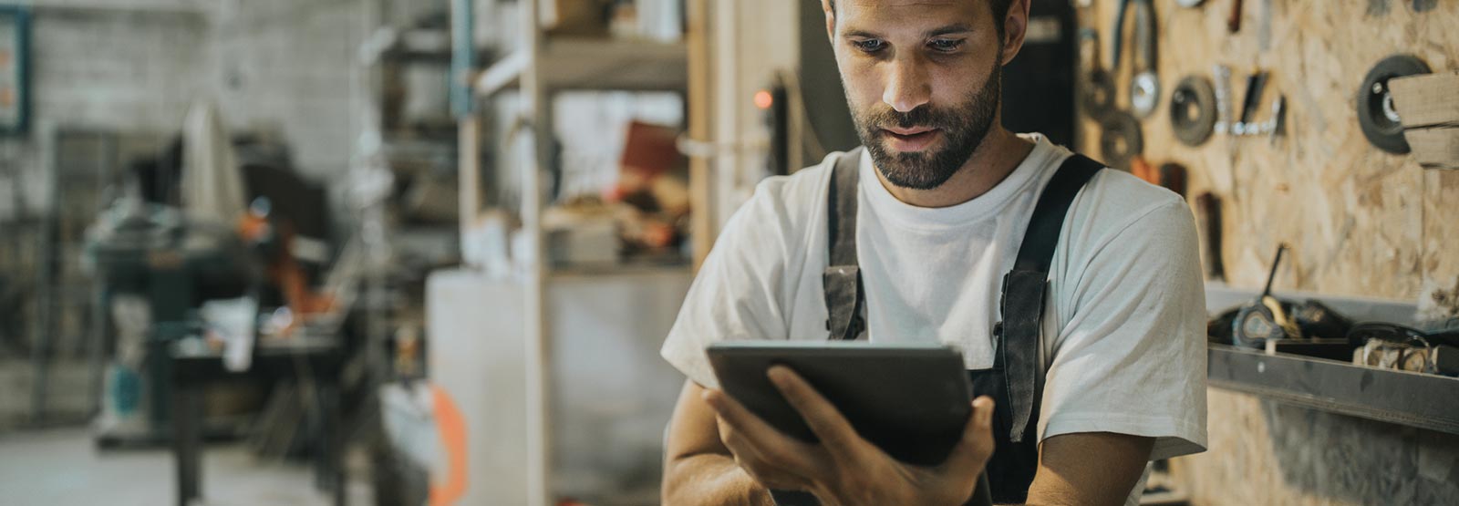 A man using a smart tablet in his business