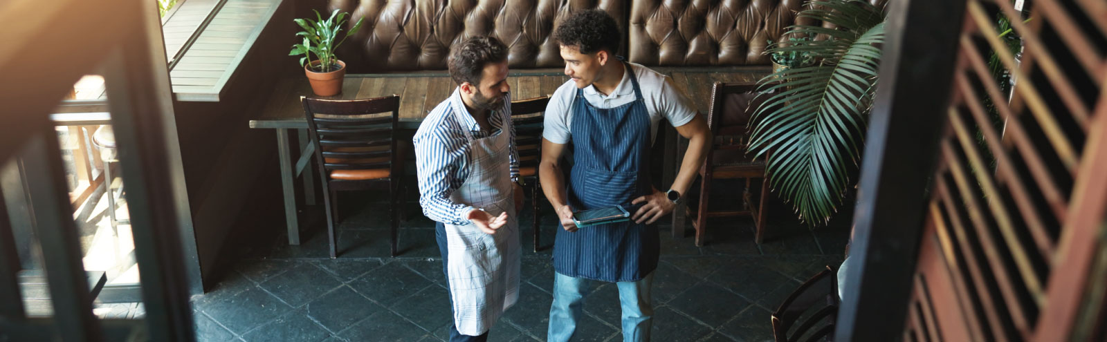 Managers having a discussion in their restaurant.