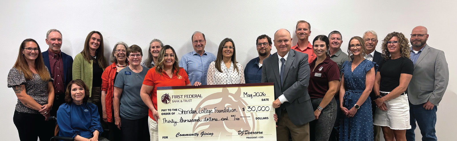 Group of Sheridan College board members and First Federal employees holding a $30,000 donation check.