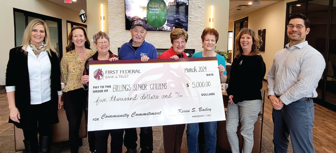 People holding a check for Billings Senior Citizens.