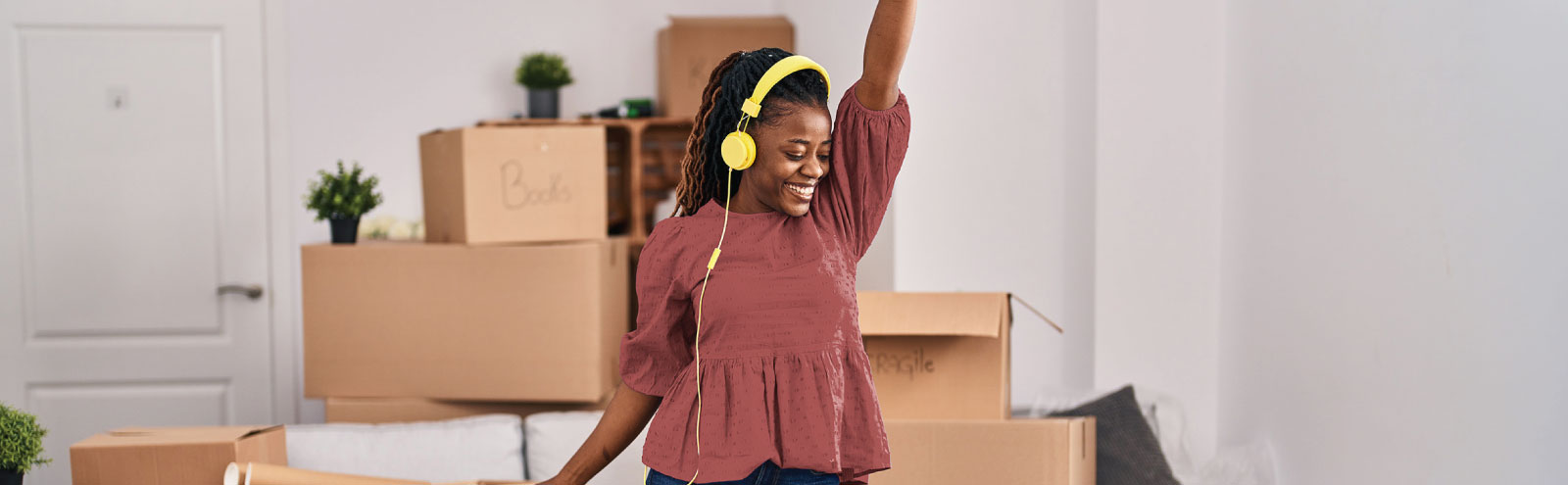 Woman dancing in front of moving boxes