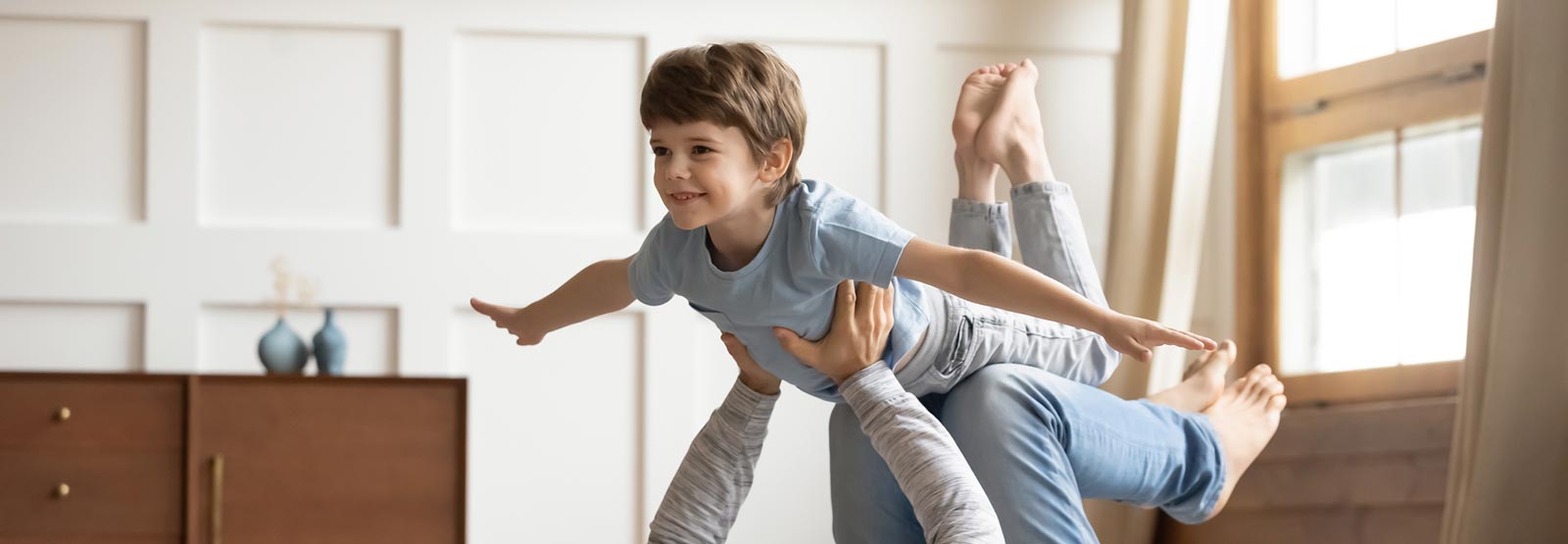 A dad and son playing in their living room