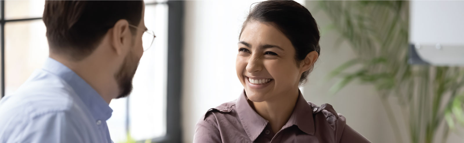 Female co-worker smiling at male co-worker