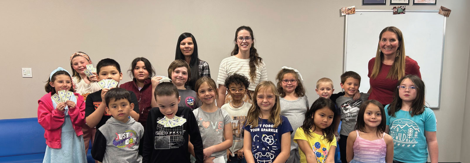 First Federal employees pose with local students who completed the Junior Achievement program.