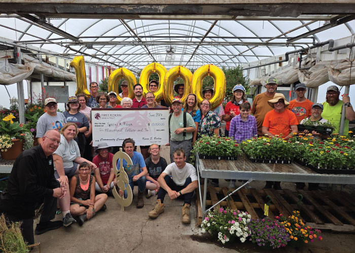 First Federal employees presenting $10,000 check to members of Special K Ranch.
